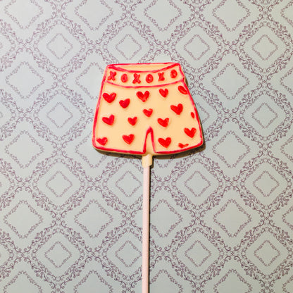 QUEST XO Cheekly Lolly: Boxer shorts lolly with red hearts on an intricate background.