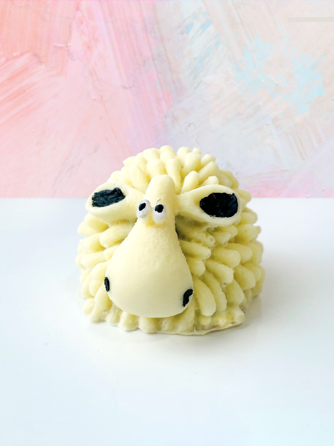QUEST XO Sheepy Hot Cocoa Bomb: Yellow sheep cocoa bomb on a light-coloured backdrop.